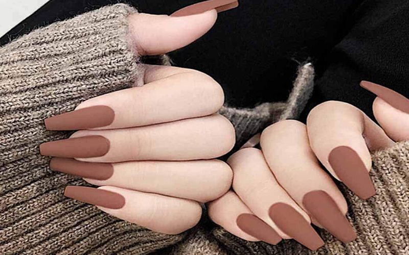 Soft blush manicure with metallic butterfly details